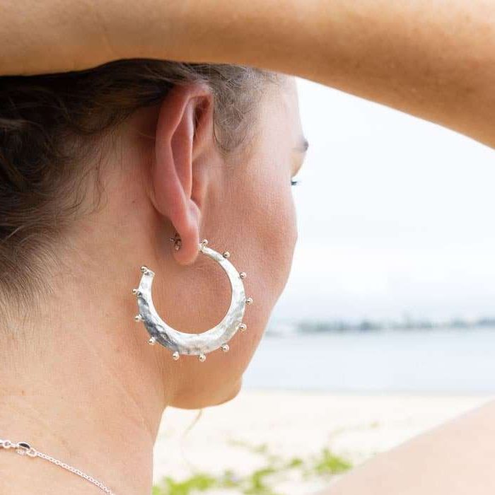 10 things to consider when buying Australian made jewellery - Kaikoa Designs women wearing sterling silver hoop earring with beach inspired design made in Australia
